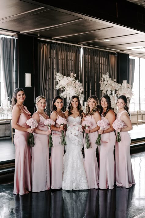 The bride and bridesmaids posing in blush pink gowns with blush bouquets. Wedding With Pink Color Schemes, Blush Pink Bridesmaid Dresses Mismatched, Black And Pink Bridesmaid Dresses, Pearl Pink Bridesmaid Dresses, Black And Light Pink Wedding, Black White Blush Wedding, Pink Black White Wedding, Bridesmaid Dresses Blush Pink, Blush And Black Wedding