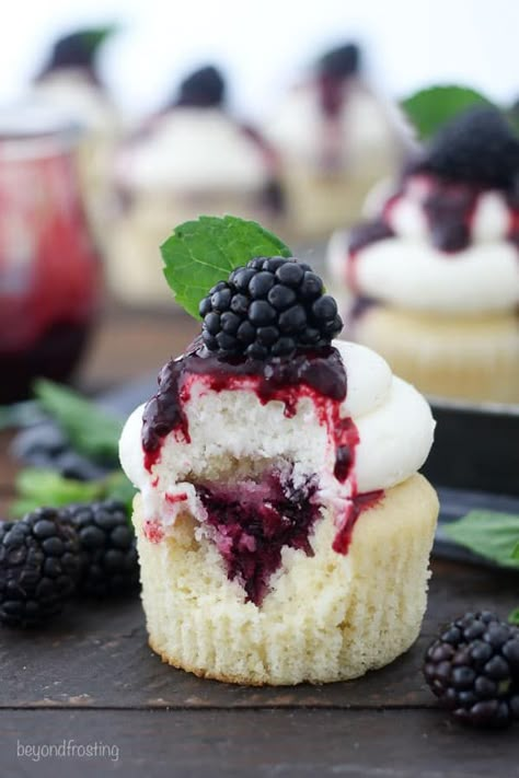 These Blackberry Bourbon Smash Cupcakes are vanilla bourbon cupcakes with a blackberry mint infused filling and topped with a vanilla bean buttercream. #cupcakes #blackberry #blackberrycupcakes #bourbon #bourboncupcakes #blackberrybourbon #homemadecupcakes Berry Filled Cupcakes, Cupcakes With Fruit On Top, Fruit Filled Cupcakes, Blackberry Bourbon Smash, Bourbon Cupcakes, Cupcakes Rellenos, Boozy Cakes, Blackberry Cupcakes, Blackberry Bourbon