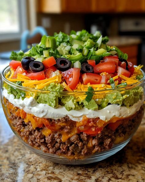 Layered with fresh veggies, cheese, and zesty taco flavors, this Seven-Layer Taco Salad is a fun, delicious, and crowd-pleasing twist on a classic favorite! 🌮🥗 #TacoSalad #LayeredSalad #PartyFood #MexicanCuisine Layer Taco Salad, Fiesta Salad Recipe, Layered Taco Salads, Taco Salad Ingredients, Fiesta Salad, Mexican Salad Recipes, Southwest Recipes, Layered Salad Recipes, Taco Salad Recipe