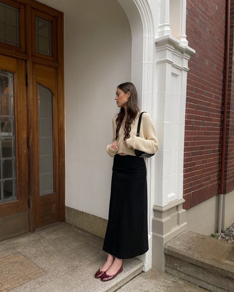 Maroon ballet flats, black maxi skirt, pale yellow knit cardigan, ootd Skirt Flats Outfit, Long Skirt With Flats, Office Maxi Skirt, Style Black Long Skirt, Ballet Flats With Dress Outfit, Midi Skirt With Ballet Flats, Black Ballet Flat Outfits, Flats With Skirt, Ballet Pumps Outfit 2023