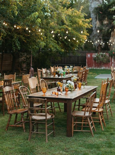 Backyard Table Decor, Retro Inspired Wedding, Mix Match Chairs, Wedding Reception Chairs, Birthday 20, Green Backyard, Mismatched Chairs, Wedding Glassware, Wooden Table And Chairs