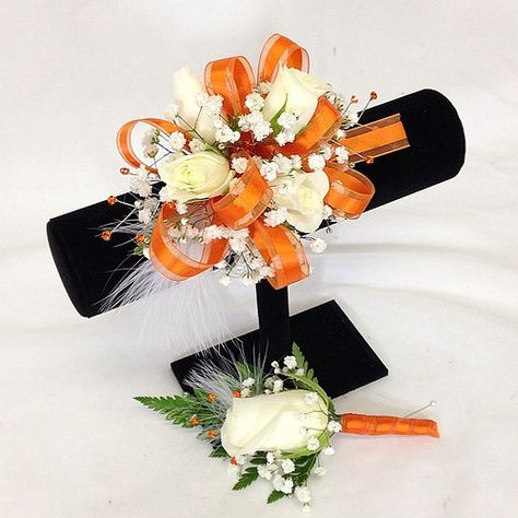 White rose wrist corsage & matching boutonnière with orange ribbon & rhinestones and white feathers. Orange And White Corsage And Boutonniere, Prom Flowers Corsage Orange, Orange And White Corsage, Orange Prom Corsage, Orange Corsage And Boutonniere, Orange Corsage, Prom Orange, Homecoming 2023, Rose Wrist Corsage