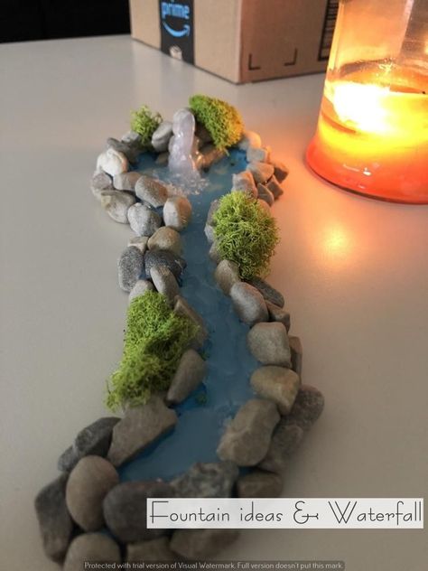 Incorporating a water fountain with LED lights into your decor can transform any space into a serene and visually appealing environment Miniature River, River Waterfall, Fairy Garden Furniture, Fairy Garden Designs, Fairy Garden Crafts, Christmas Village Display, Fairy Garden Houses, Fairy Garden Ideas, Christmas Nativity Scene