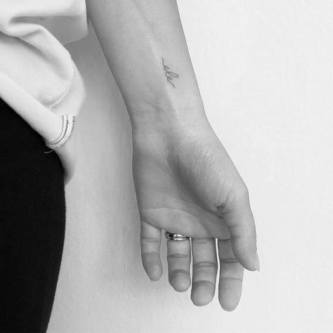 Tiny Tattoo For Daughter, Small Mom Tattoo Ideas, Tattoo Ideas For New Moms, Minimal Mom Tattoo, Dainty Tattoo For Kids, Fine Line Name Tattoo Wrist, Small Kids Name Tattoos For Women, Baby Initial Tattoos, Small Tattoo For Daughter