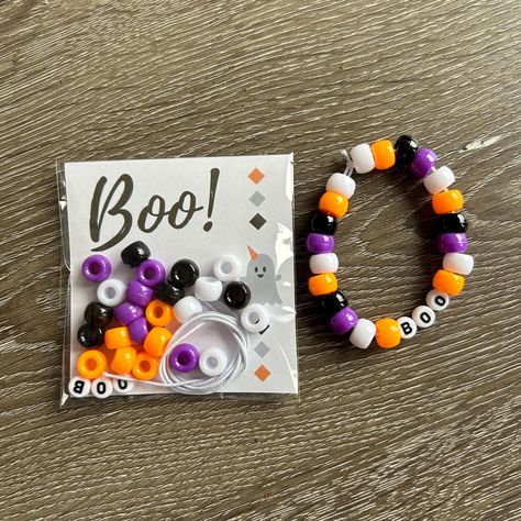 Looking for a fun interactive way to celebrate Halloween this year? Look no further! Personalized Individually Wrapped DIY Halloween Bracelet Kit is a great classroom or Girl Scout troop gift!  Each kit comes with: 12 inches of white elastic for bracelet  24 beads (6 white - 6 black - 6 purple - 6 orange) BOO letter beads (1 B - 2 O's) Beads & elastic is placed in a clear tube !  WARNING: CHOKING HAZARD - Small parts. Not suitable for children under 3 years. Halloween Boo Baskets For Kids, Halloween Beaded Bracelets Diy, Diy Halloween Bracelets, Halloween Beaded Bracelets For Party, Halloween Bracelet Craft, Halloween Gift Stretch Bracelet, Handmade Halloween Festival Bracelets, Halloween Beaded Bracelet, Halloween Gift Beaded Bracelets