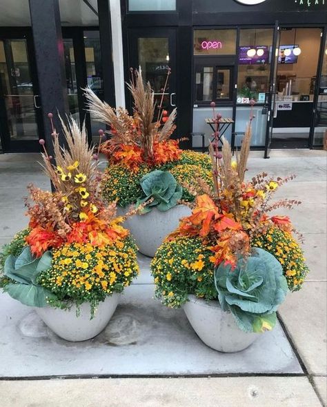 Creating Fall Container Planters is a Fantastic Way to Bring the Beauty of Your Outdoor Space - (10 Wonderful Ideas) - Decomagz Water Trough Planter Fall, Fall Pot Arrangements, Fall Planter Arrangements Outdoor, Faux Fall Plants For Front Porch, Fall Front Door Flower Pots, Mum Hanging Baskets, Mum Pot Ideas, Halloween Outdoor Pots, Fall Flower Pot Arrangements Outdoor