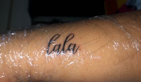 This is a written tattoo saying “lala” Gramma Tala Tattoo, Lala Tattoo, Ariola Tattoo, C’est La Vie Tattoo Ideas, Writing Tattoos, Name Tattoos, Jesus Fish Tattoo, Small Tattoos, Tattoo Quotes