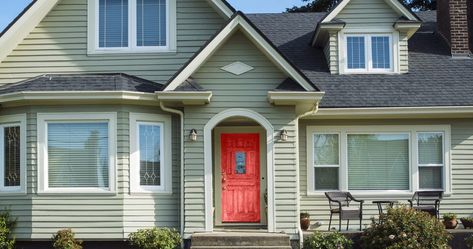 Having a green house may seem intimidating when it comes time to coordinate the colors for your exterior, such as the door. If you’re wondering what c... | 13 Flirt Alert scaled Green House Siding, Sage Green House Exterior, Green Siding House, Light Green House, House Doors Colors, Green House Color, Sage Green House, Exterior Front Door Colors, Green Exterior Paints