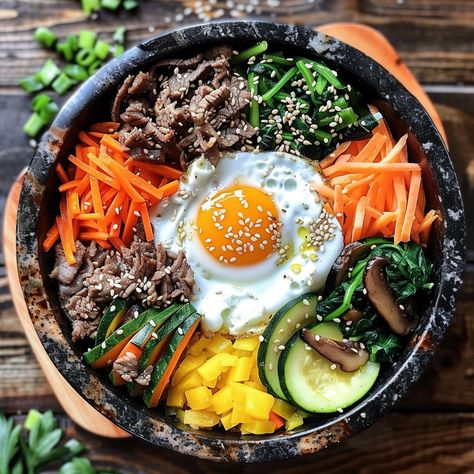 🍚 Enjoy the savory Bulgogi Dolsot Bibimbap! 🍲✨ #Bibimbap #KoreanCuisine Bulgogi Dolsot Bibimbap (Mixed Rice in a Hot Stone Pot) Ingredients: Bulgogi beef, sliced thinly (1/2 lb) Cooked rice (2 cups) Carrots, julienned (1 cup) Zucchini, julienned (1 cup) Spinach, blanched (1 cup) Bean sprouts, blanched (1 cup) Mushrooms, sliced (1 cup) Egg (1) Gochujang (Korean chili paste) (2 tbsp) Soy sauce (2 tbsp) Sesame oil (1 tbsp) Sesame seeds (1 tbsp) Vegetable oil (for cooking) Instructions: Marin... Banchan Korean Side Dishes, Bulgogi Gimbap, Korean Food Bibimbap, Bulgogi Bibimbap, Beef Bibimbap, Korean Meals, Dolsot Bibimbap, Korean Ingredients, Korean Bibimbap