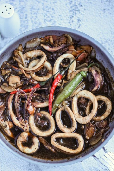 This tasty Squid Adobo (Adobong Pusit) takes a delightful twist with its tender squid that absorbs flavors from the marinade and incorporates its ink for intense adobo flavor. This rich, savory, and tangy dish is easy to make a perfect idea for busy weekdays. Squid Adobo Filipino Food, Adobong Pusit Recipe, Pusit Recipe, Adobong Pusit, Adobo Recipe, Savory Food, Filipino Food, Calamari, Vietnamese Recipes