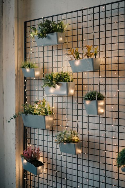 Cascading greenery and potted plants attached to a black metal grid on a living room wall. Wall Mounted Plant Shelves, Plant Shelves On Wall, Apartment Plant Wall, Slat Plant Wall, Wall Plants Indoor Living Rooms, Diy Wall Planter Indoor, Indoor Wall Planter Ideas, Hanging Plants Indoor Ideas, Plant Wall Ideas Indoor