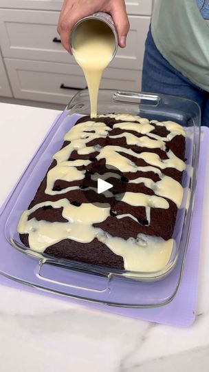 10K views · 274 reactions | This dessert is better than anything else! | This dessert is better than anything else!

Kyra makes an easy chocolate poke cake with cool whip as the frosting. | By Kyra Dawn | Alright, we have a can of
sweetened condensed milk here and we're just going to pour it
right into the holes we poked into our prepared dark
chocolate fudge cake. Just a premade, you know, store-bought
cake mix and I went ahead and heated up my can of condensed
milk in a cup of really hot water and that's how I got it
to pour like this. It's going to be like the cake that
you've ever had. So just get all that condensed milk out of
there. And we need to go ahead and let the cake cool down for
about 30 minutes on the counter. Alright you guys. I
let this cool down completely. I had it in th Poke Cakes Condensed Milk, Easy Chocolate Poke Cake, Cake With Cool Whip, Dark Chocolate Fudge Cake, Condensed Milk Desserts, Chocolate Box Cake, Ding Dong Cake, Condensed Milk Cake, Sweet Condensed Milk