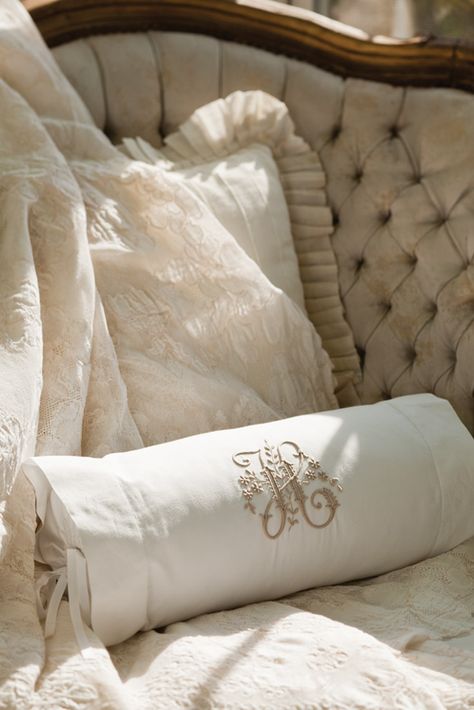 Intricate embroidery rendered in taupe on a crisp white bolster pillow plays off the earthen tones and carvedwood accents of this tufted-velvet settee. Bolster Pillow On Bed, Velvet Settee, Monogram Bedding, Monogram Pillow, Victoria Magazine, Romantic Bed, Embroidery Pillow, Bolster Pillows, Monogram Pillows