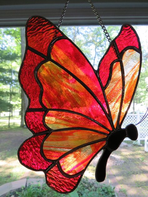 Hand crafted stained glass orange/red butterfly suncatcher created with care in our home shop using quality materials. The glass is variegated orange with variegated red wingtips.  Each piece is uniquely made, none is like the one before it. Each piece is designed to add beauty and charm to your home for many years to come. The glass looks different in different lights, so actual color may be slightly different, although every effort has been made to show accurate color. Stained Glass Butterflies Pattern, Stain Glass Butterflies, Butterfly Stained Glass, Butterfly Stained Glass Pattern, Butterfly Stained Glass Window Art, Stained Glass Monarch, Stained Glass Insects, Stained Glass Monarch Butterfly, Stained Glass Butterfly Mobile