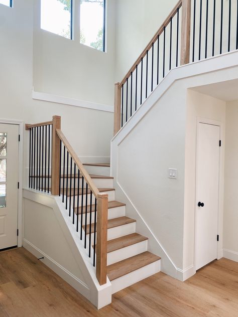 Modern Farmhouse Wrought Iron Staircase. Bilevel Staircase Ideas, Dark Railing Light Floor, Stair Cable Railing, Modern Stairs Railing, Stairs And Railing Ideas, White Stair Railing Ideas, Old Home Staircase Remodel, Wood Stair Railing Ideas Modern, White And Wood Stair Railing