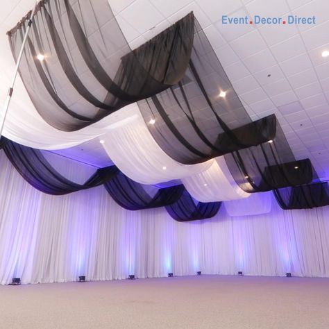 EventDecorDirect.com is the #1 supplier of professional ceiling draping kits at factory-direct prices. Choose from a huge variety of styles, colors and sizes. We also offer accessories that allow you to drape a ceiling without a ladder! Our ceiling draping kits are ideal for weddings, events, parties, corporate events, banquet halls, event centers and much more. Enjoy FREE SHIPPING on all of our ceiling draping kits. Shop Now at EventDecorDirect.com | Questions? Call Us Today 1-800-914-3538 How To Decorate A Ceiling For A Party, Roof Draping Ideas, Wisteria Chandelier Wedding Diy, How To Hang Ceiling Draping, Ceiling Draping Diy, Party Hall Decor Ideas, Ceiling Decorations For Party, Wedding Ceiling Draping, Table Decorations Vintage