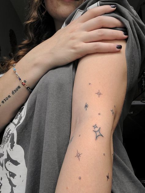 Star tattoo on arm Stars Around Moon Tattoo, Scattered Star Tattoos, Star Patchwork Tattoos, Sparkle Tattoo Sleeve Filler, Star Tattoos Leg, Thigh Star Tattoo, Star Hip Tattoos Women, Stars Wrapped Around Arm Tattoo, Twinkle Stars Tattoo