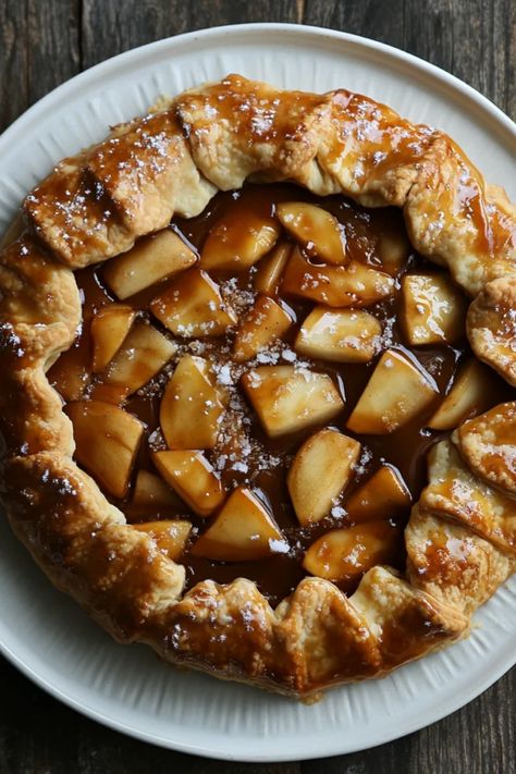 Indulge in a delectable rustic salted caramel apple galette, featuring a flaky crust filled with sweet apples and topped with warm caramel. Perfect for dessert lovers, this delightful recipe mixes comforting flavors with seasonal ingredients. The pin includes one image showcasing this stunning pie. Caramel Apple Galette Southern Living, Apple Pie Crust Ideas, Apple Galette With Pillsbury Pie Crust, Caramel Apple Galette, Apple Galette Recipe, Apple Tartlets, Apple Tarte, Apple Tarts, Traditional Turkey