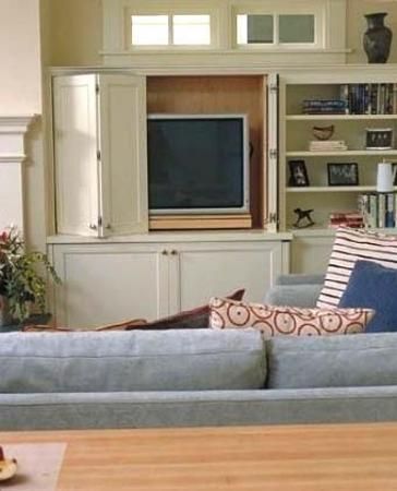 Hiding TVs behind hinged and sliding doors or wall decorative panels is one of interior design trends and modern ideas for home staging Built In Tv Cabinet, Hidden Tv Cabinet, Tv Cupboard, Contemporary Family Room, Tv Built In, Tv Cabinet Design, Hidden Tv, Basement Renovation, Fireplace Built Ins