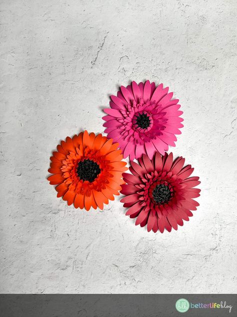 Beautiful Paper Gerbera Daisies – How to Make Cricut Paper Flowers￼ – Better Life Blog Cricut Paper Flowers, Making Paper Flowers, Rolled Paper Flowers, Hanging Craft Ideas, Gerbera Daisies, Paper Wall Hanging, Hanging Craft, Flowers Craft, Craft Wall