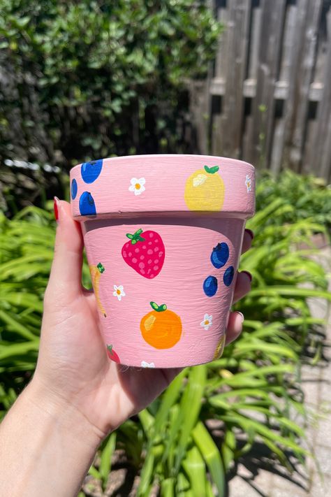 I’ve been obsessed with all the cute painted terracotta pots I’ve seen on Etsy and Pinterest lately, so I decided to give it a try and make my own.  It’s a fun, creative way to personalize my space without breaking the bank. Plus, it’s a great DIY project to tackle over the weekend! In this post, I’ll walk you through how to paint terracotta pots and turn them into colorful, customized masterpieces. Painting On Household Items, Painting On A Pot Ideas, Painted Pot Aesthetic, Flower Pot Color Ideas, Painting Ideas On A Pot, Painting Clay Flower Pots, Cute Plant Pot Painting Ideas, Painting Pots Terracotta, Painting Pot Plants