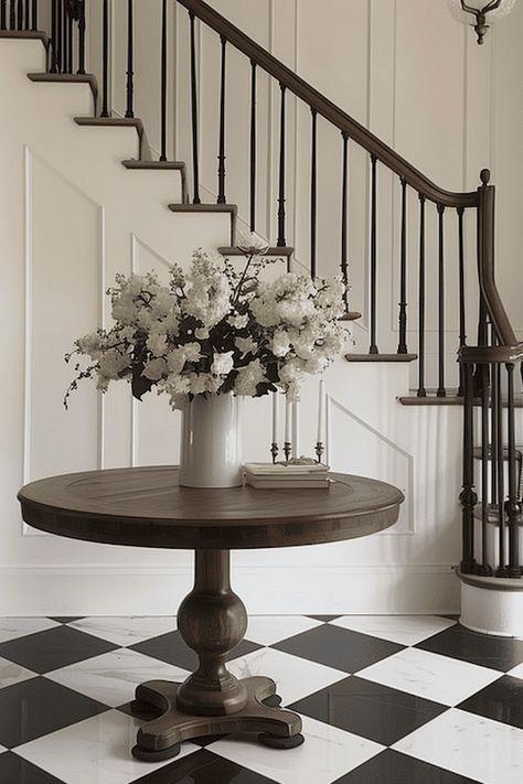 18 Impressive Entryway Decor Ideas For A Foyer That Wows Harlequin Floors Entry, Foyer Ideas Entryway Stairs, Round Foyer Table Decor Entryway, Round Foyer Table Decor, Large Foyer Ideas Entryway, Large Entryway Ideas Foyers, Large Foyer Ideas, Large Entryway Ideas, Classic Entryway