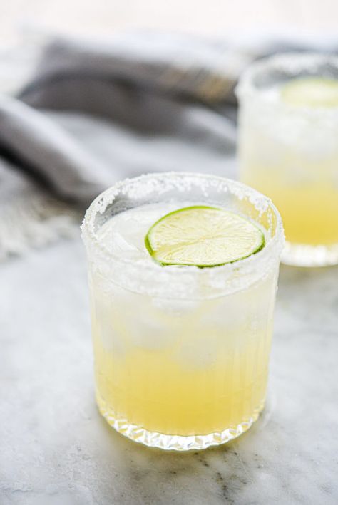 two salt rimmed glasses of skinny margarita sitting on a marble surface Grand Marnier Margarita, Blended Margarita Recipe, Agave Margarita Recipe, Blended Margarita, Lavender Lemon Drop, Fresh Margarita Recipe, Lemon Drop Recipe, Agave Margarita, Frozen Watermelon Margarita