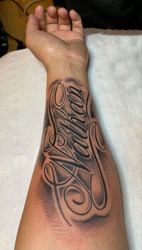 Name Tattoo On Bicep, Name Style Tattoos, Arm Tattoos For Guys Forearm Ideas, Last Name On Arm Tattoo, Men Name Tattoos For Women, Forearm Tattoos Lettering, Name Tattoo With Shading, Sleeve Tattoos With Names, Men’s Name Tattoos