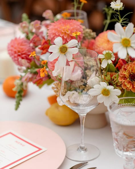 Not only do these vibrant flowers enhance the overall aesthetic of your wedding, but they also create a cheerful and celebratory atmosphere, setting the perfect mood for your special day. Adding a pop of fresh citrus ties the whole look together seamlessly! #weddingflowers #colorfulblooms #floraldecor #weddingreception #vibrantflowers #alinatoevents #brideandblossom #overthemoon #stylemepretty #colorfulflowers #weddingflorals #nycweddingplanner #weddingplanner Citrus Wedding Colors, Citrus Wedding Florals, Citrus Wedding Flowers, Fruit Inspired Wedding Decor, Boho Citrus Wedding, Spring Citrus Wedding, Pops Of Color Wedding, Citrus Color Wedding, Citrus Theme Wedding