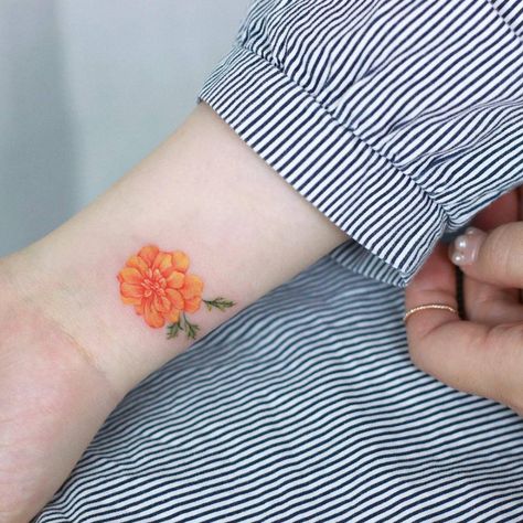 Marigold tattoo on the wrist. Small Marigold Tattoo, Marigold Tattoo, Flower Tattoo Meanings, Foot Tattoos For Women, Small Flower Tattoos, Inspiration Tattoos, Birth Flower Tattoos, Flower Tattoo Sleeve, Tatuaje A Color