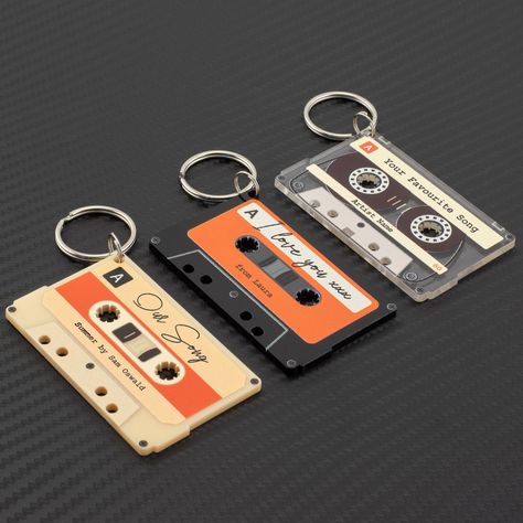 Personalised Retro Cassette Tape Keyring How does it work? Pick a colour and font, send us your custom message or song/artist name for the upper and lower strip of the keyring. Laser cut and UV printed to look like a scaled down retro cassette tape Scratch resistant primer for long lasting print Exceptional quality 1200dpi print Free 2nd class UK postage Low cost international postage Size: 70mm x 43mm x 3mm ALL KEYRINGS HAVE A PROTECTIVE LAYER ON THE BACK THAT NEEDS PEELED OFF. Other STYLES, SI Valentine Music, Retro Cassette, Song Artists, Cassette Tape, Cassette Tapes, Music Stuff, Key Chains, Print Gifts, Low Cost