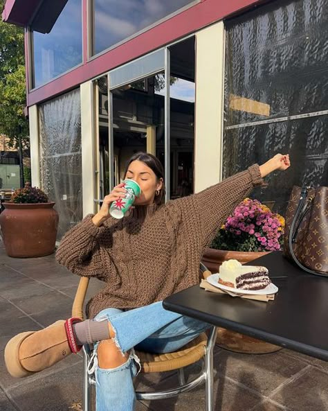 Image featuring a girl wearing Ugg Tazz Slippers, a brown sweater, blue jeans, and brown socks, showcasing a trendy fall college outfit. Perfect blend of comfort and style for fall fashion inspiration. New Fall Fashion 2023, Everyday Fall Outfits Casual, Fall Outfits Chunky Sweaters, Ugh Razz Slipper Outfit, Outfits With Platform Tasman Uggs, Knit Brown Sweater, Fall Outfits Knit Sweaters, Ugg Tazz Outfit Fall, Fall Clothing Photoshoot