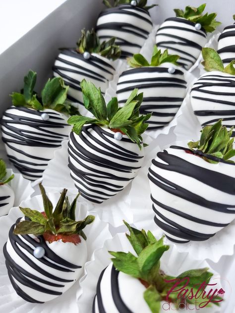 Strawberries dipped in white chocolate, striped with black chocolate and with a silver pearl. Call or email us to design your dream dessert today! #chocolateberries #chocolatecoveredstrawberries #chocolatetreats #desserttables #treattableideas #strawberries #birthdaytreats #dinnerpartyideas Black And White Stripe Decor Party Ideas, Black Dipped Strawberries, Black And White 40th Birthday Decor, Black And White Party Foods, Black White And Silver Party Ideas, White And Silver Strawberries, Black White And Silver Birthday Party, Black White Dessert Table, 40th Birthday Black And White