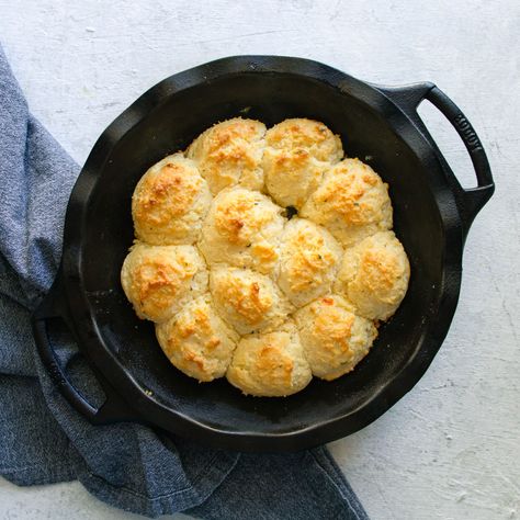 3 ingredient buttermilk drop biscuits are the perfect addition to any weeknight dinner. Made with self-rising flour, buttermilk, and butter - you only need one bowl and bake for 15 minutes. Scooped out and baked in a cast iron skillet, these biscuits are a quick and easy version of a Southern staple recipe. Buttermilk Drop Biscuits Easy, Drop Biscuits With Self Rising Flour, Cast Iron Drop Biscuits, Drop Buttermilk Biscuits, Buttermilk Biscuits In Cast Iron Skillet, Cast Iron Buttermilk Biscuits, Buttermilk Biscuits Self Rising Flour, Biscuits Self Rising Flour, 3 Ingredient Biscuit Recipe