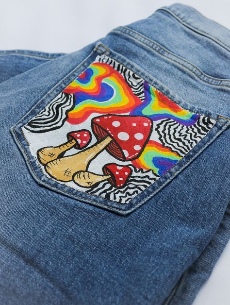 Trippy hippie up cycled blue jeans! 🌈✨❤️🎨
Hand-painted with vibrant rainbows mushrooms and an eye. These pants have been heat-set so the paint is permanent

washing instructions:
Hand wash with cold water mild detergent or if really dirty, turn it inside out and wash on a gentle cold cycle with mild detergent. Aesthetic Painted Jeans, Custom Painted Clothes, Art On Pants, Hand Painted Jeans, Custom Jeans Diy, Custom Jean, Diy Pants, Painted Clothes Diy, Diy Aesthetic