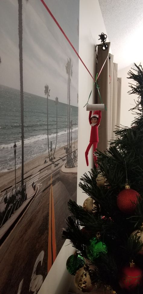 Zipline Elf On The Shelf, Elf Hanging From Ceiling, Elf On The Shelf Ideas Zipline, Elf On Shelf Ziplining, Elf Swinging From Ceiling Fan, Swinging Elf On The Shelf, Elf On The Shelf Hanging From Fan, Elf On The Shelf Swing Diy, Elf Zipline Ideas