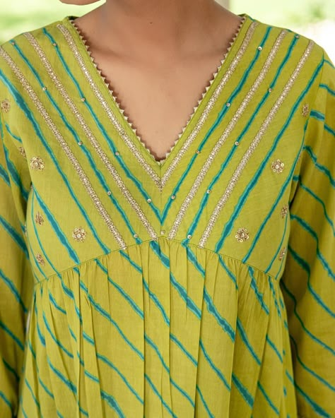 ~HARMONY OF HUES~ Lehariya Collection - New Arrivals! A fresh vibrant look with teal Lehariya contrasting against a lime green base. Rows of silver gota enhance the elegant neckline and sleeve cuffs. This is a standout piece for festive occasions. [ Cottons Jaipur, Cotton, Lehariya, Rajasthan, Handcrafted, Traditional, Ethnic] #cottons #cottonsjaipur #newarrivals #rajasthan #heritage #traditional #lehariya #lehariyasuits #kurta #craftmanship #indianart #colours #indian #ethnic #cottonkur... Cotton Lehriya Kurti Designs Latest, Lehriya Kurti Designs, Lehariya Kurti Designs, Cottons Jaipur, Kurti Neck Design, Embroidery Kurti, Neck Patterns, Long Frock Designs, Frock Designs