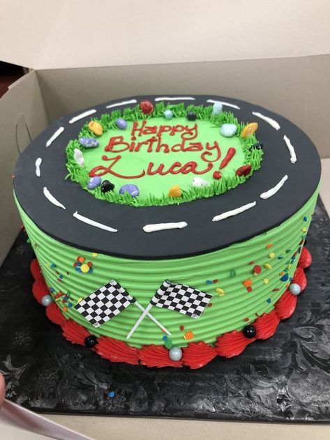 buttercream cake with fondant race track and paper checkerflags in front Racetrack Birthday Cake, Buttercream Race Car Cake, Growing Up 2 Fast Birthday Cake, Buttercream Car Cake, Simple Race Car Cake, Vintage Car Birthday Cake, Race Car Birthday Cake Ideas, Need 4 Speed Birthday Cake, Racecar Birthday Cakes