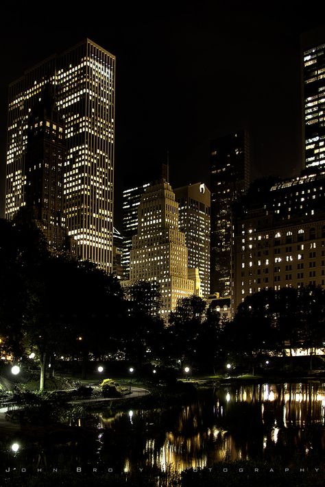 Skyline Reflection of Central Park NYC  by the Plaza and the well known NYC Apple Store. Photo taken from the Gapstow Bridge at the southernmost corner of Central Park near Wollman Ice Skating Rink, yes, the skating rink in almost every movie made in Central Park including Serendipity, Limitless, and Love Story to name a few :)   -   JohnBrody.com / John Brody Photography City Widgets, Central Park Nyc, Vibe Check, Nyc Aesthetic, Dark City, Nyc Life, New York Aesthetic, New York Life, City Vibe