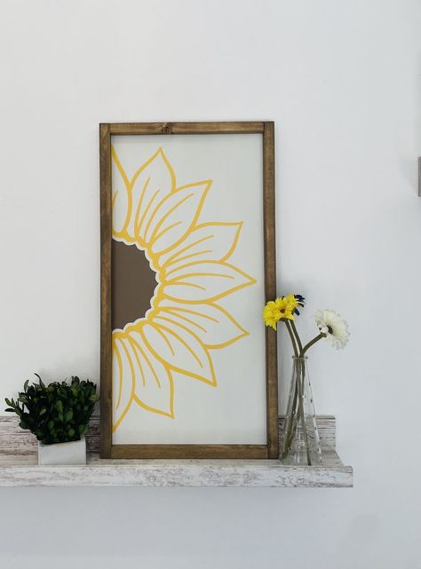 This is a beautiful Modern Farmhouse Sign.
This sign can either stand on its own or be hung on the wall.
Great as a gift for any occasion, or to keep for yourself!
Perfect for any living room!

-This sign is about 12"X23"X0.75"
-Made out of light weight wooden board and the frame is solid wood
-Painted with high quality paint
-Background color is Alabaster
-Sunflower is Tiki Hut brown and Butterfield yellow
-Frame is stained with your choice of a Walnut, Natural, or Gray stain Sunflower Signs Diy, Beautiful Modern Farmhouse, Sunflower Sign, Flower Sign, Gray Stain, Plant Pot Design, Yellow Frame, Barn Signs, Pot Design