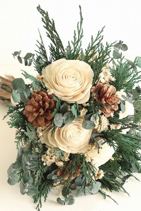 This seasonal bouquet might be charming for your special day. As a wedding enthusiast, this one completes a winter-themed wedding. Pin this inspiration to your bouquet selection. Winter Green Bouquet, Greens Bouquet, Woodland Wedding Bouquet, Pine Wedding, Christmas Greens, Romantic Winter Wedding, Vintage Lace Weddings, Winter Green, Green Bouquet