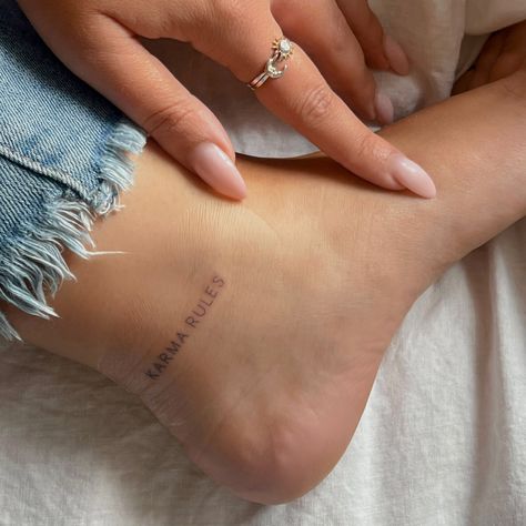 Harry Styles Ankle Tattoo, Karma Rules Tattoo, Karma Rules Tattoo Harry Styles, Tattoos Ankle, Karma Tattoo Design, Tattoo Karma, Harry Styles Inspired Tattoos, Back Of Ankle Tattoo, Heel Tattoos