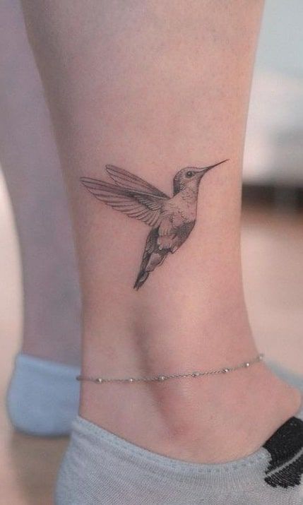 Black Ink Hummingbird Tattoo, Women Leaf Tattoo, Humming Bird Tattoo Wrist, Hummingbird Tattoo With Script, Tattoos Of Hummingbirds, Push Through Tattoo, Tattoo Of Hummingbird, Humming Tattoo Bird, Flying Hummingbird Tattoo