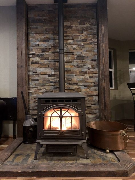 Wood Stove With Chimney, Wood Burning Stove Cabin, Galvanized Tin Walls Fireplace, Farmhouse Wood Stove Surround, Diy Woodstove Surrounds, Woodstove Backdrop Ideas, Pellet Stove With Stone Wall, Wood Stove Between Windows, Wood Stove Placement