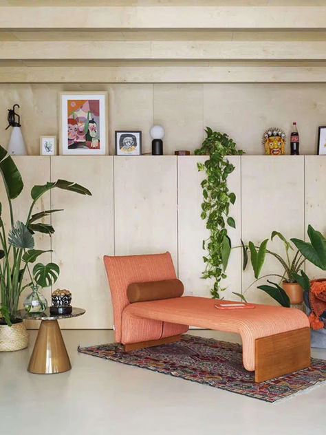 A curved, green upholstered bench with rolled arms and cylindrical bolsters, featuring a low profile and tapered metal legs. The bench is placed in front of a white wall adorned with a large, abstract hanging artwork featuring bold colors and geometric shapes. Conversations With Friends, Waiting Area, The Bedroom, Public Space, Modern Furniture, Contemporary Design, Dreaming Of You, Interior Decorating, Bench