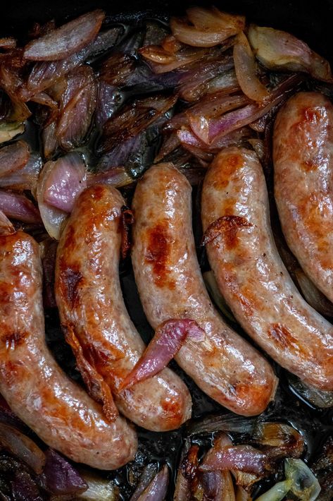 An easy and delicious method for cooking bratwurst, these Easy Oven Baked Brats with Roasted Onions comes together in about 30 minutes, for a delicious and mess-free way to make brats for dinner! Bratwurst And Onions, Oven Brats, Bake Brats In Oven, Brats With Peppers And Onions In Oven, Bratwurst Oven, Bratwurst Dinner, Oven Braised Beer Brats With Caramelized Onions, Beer Braised Brats And Onions, Beer Brats With Peppers And Onions