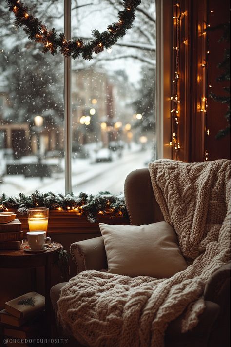 Bring the warmth of winter indoors with this cozy Christmas wallpaper. Featuring a snug armchair draped with a knitted blanket, glowing candles, and a snowy street scene through a garland-adorned window, this image captures the peaceful charm of the holiday season. Perfect as a calming and festive phone background. Download now for holiday vibes! Click the link to check out our Wildlife Gathering for Christmas Cards! Snug Armchair, Cozy Christmas Wallpaper, Cozy Winter Aesthetic, Snowy Street, Frosted Window, Frosted Windows, Candle Glow, Cozy Chair, Knitted Blanket