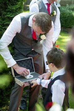 Wedding Photography - Ceremony - Page boy - Ring bearer - Security - Suitcase - Handcuffs - Grey suit - Red tie Blue Line Wedding, Law Enforcement Wedding, Ring Bearer Security, Grey Suits, London Wedding Venues, Future Wedding Plans, Wedding Photos Poses, Floral Arrangements Wedding, Cute Wedding Ideas