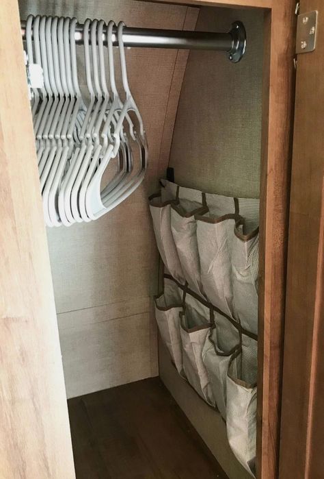 Camper Shell Organization, Rv Linen Storage, Trailer Ideas Organizing, Camper Set Up, Small Rv Storage Ideas Travel Trailers, Camper Dinnete Remodel, Camping Shoe Storage Ideas, Clothes Organization Camper, Rv Slide Out Decor