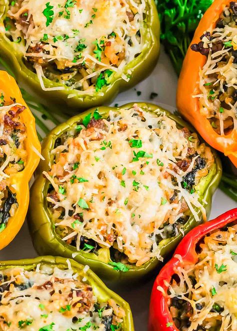 Sausage stuffed peppers are the perfect hearty meal! These delicious bell peppers are filled with Italian sausage, spinach, ricotta, and rice, then topped with melted parmesan. This easy and adaptable recipe is ideal for busy weeknights and family dinners. Stuffed Peppers With Italian Sausage, Sausage Stuffed Peppers, Italian Sausage Spinach, Stuffed Pepper Recipe, Stuffed Peppers With Rice, Bratwurst Sausage, Sausage Spinach, Pepper Recipe, Spinach Ricotta